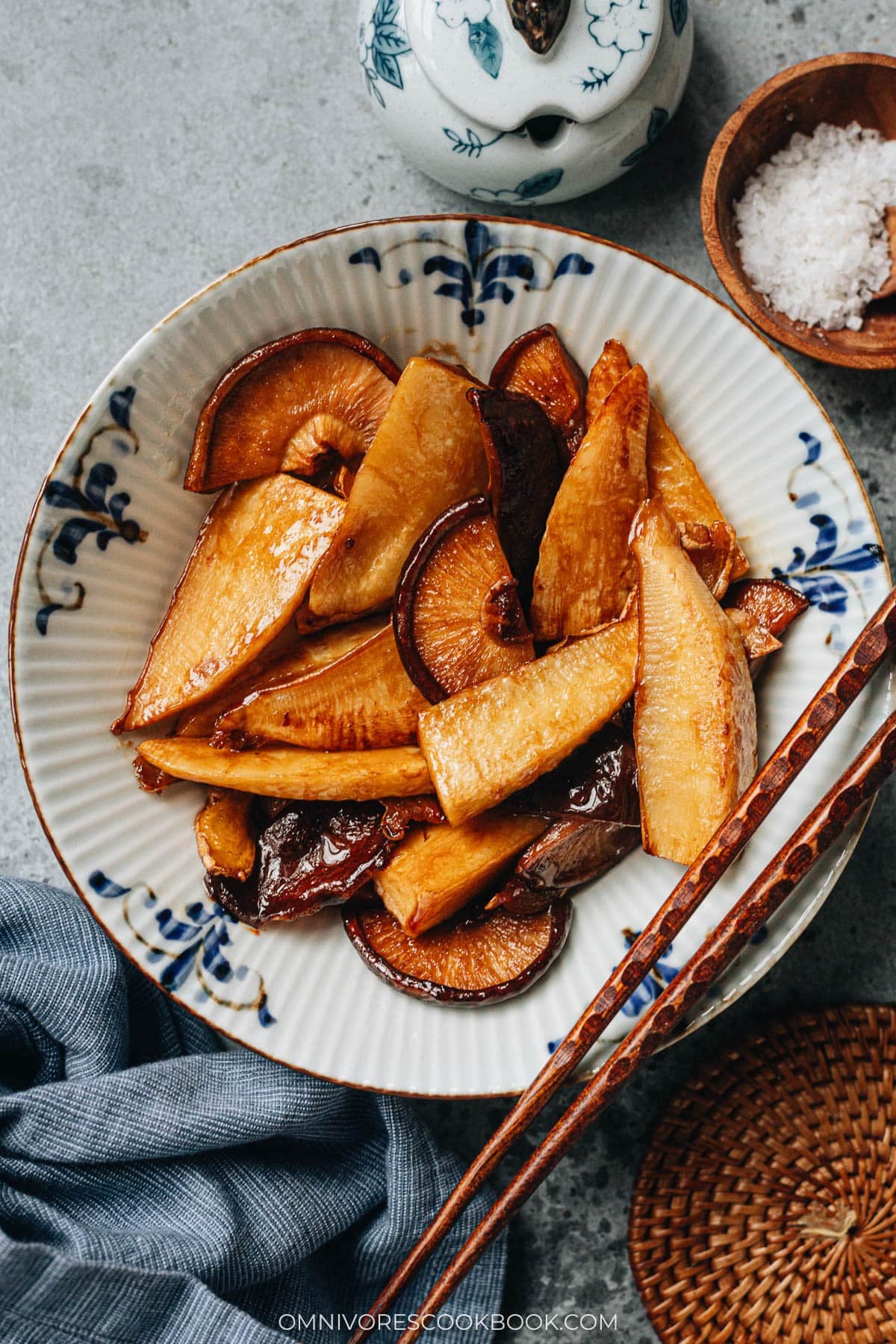 Braised bamboo shoots and shiitake mushrooms served in a bowl with chopsticks